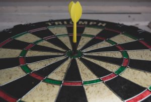 Dart board with dart in the bullseye image on dartitis blog post